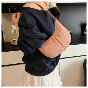 Close-up of pink lychee texture hobo bag with silver studs and side pocket details