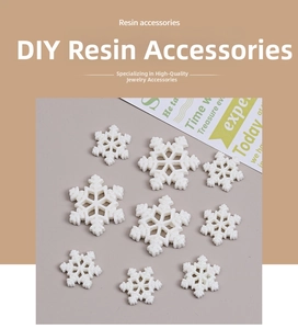 Close-up of white glittery resin snowflake charms for DIY jewelry and hair accessories