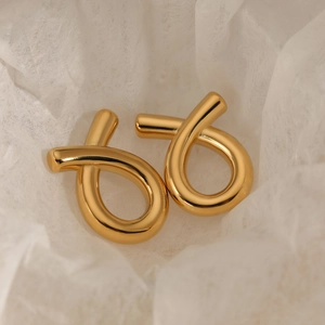 Minimalist gold knotted stainless steel stud earrings on elegant white background