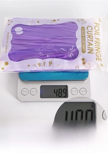 Detailed view of packaged purple foil fringe curtain weighing approximately 48.9 grams