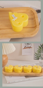 Detailed view of yellow cheese-shaped scented candles with a creative porous texture