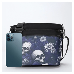 Front view of black nylon crossbody bag with gothic skull and purple floral print with phone
