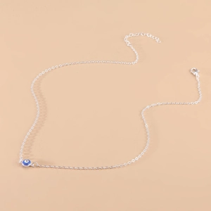 Bohemian silver clavicle necklace featuring a vintage blue evil eye pendant on fine chain