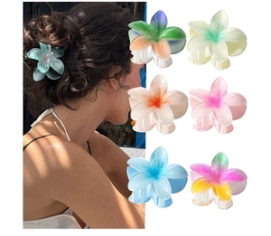 Macro detail of various colorful pearlescent plumeria flower claw clips for hair styling