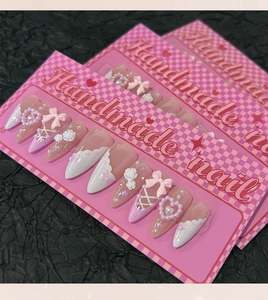 Handmade almond press-on nails with white 3D bows, roses, and pearl hearts