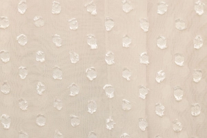 Detail of sheer cream fabric with 3D dot texture and fine mesh weave for elegant shirts