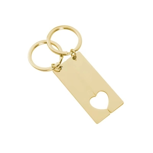 Macro shot of mirror-polished gold stainless steel heart puzzle keychains for engraving