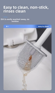 Detailed view of grey silicone toilet brush head being rinsed clean under water flow