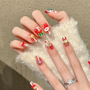 Christmas 3D press-on nails with Santa and reindeer motifs in red and green festive colors
