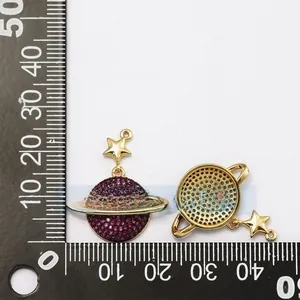 Detailed view of gold-plated Saturn pendant with ruby stones and star connector