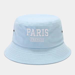 Close-up of PARIS embroidery on light blue cotton twill bucket hat with metal eyelets