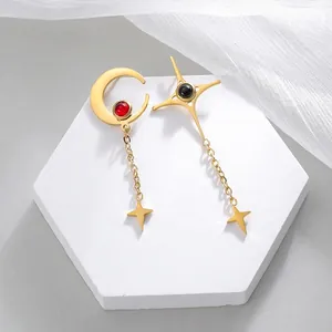 Vintage gold stainless steel earrings featuring moon and star tassels with red and black stones