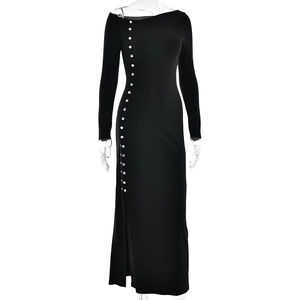 Detail view of black slim fit maxi dress featuring silver buttons and a high side slit