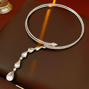 Macro detail of silver layered necklace featuring micro-set zircon and teardrop pendants