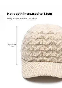 Detail view of beige cable-knit baseball cap showing 13cm deep fit and thick knit texture