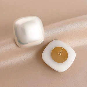 Elegant geometric square pearl stud earrings with gold metal base on champagne silk
