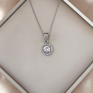 Close-up of a silver stainless steel necklace featuring a luxury round zircon pendant