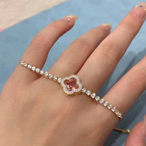 Detailed macro view of a 18K gold floral bracelet with a square pink zircon gemstone