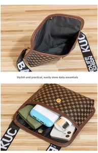 Detail view of the brown embroidered crossbody bag interior with storage capacity
