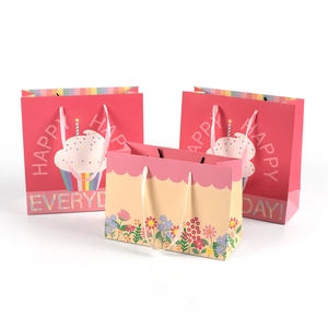 Set of 3 pink gift bags with cupcake and floral designs for parties and birthdays