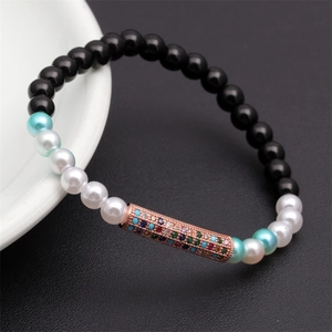 Close-up of beaded elastic bracelet with rose gold tube and colorful zircon stones