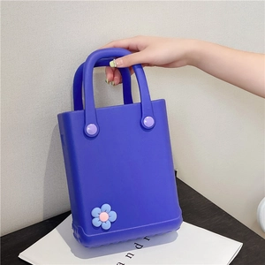 Deep blue EVA jelly tote bag with a decorative flower charm for summer beach vacation
