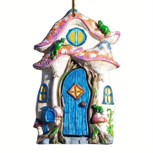 Detailed view of hand-painted fairy mushroom house ornament with blue door and frog