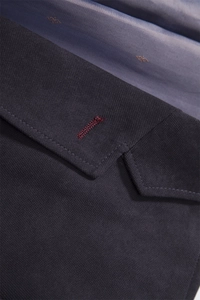 Detail of dark blue twill fabric coat with contrast burgundy buttonhole stitching