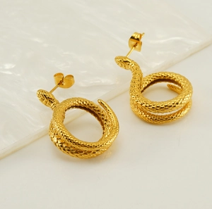 Close-up of golden snake earrings with realistic scale texture and metallic shine