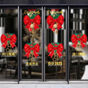 Close-up of red Christmas bow stickers with gold bells and 2025 New Year greetings on glass