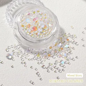 Macro shot of iridescent mermaid glass beads in a clear jar for nail art and DIY crafts