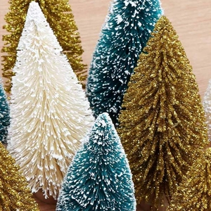Close-up of mini sisal Christmas trees with glitter powder and snow-flocked effect