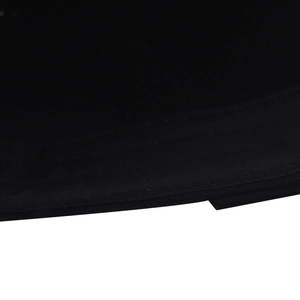 Detailed close-up of double-stitched seams on a black cotton twill baseball cap brim