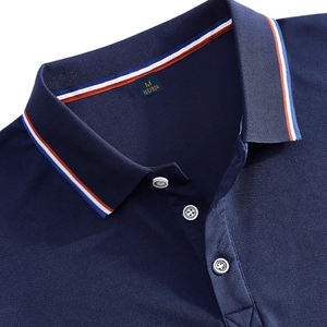 Detail of navy blue polo shirt with tricolor striped collar and pique cotton texture