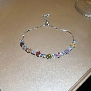 Macro detail of adjustable silver zircon bracelet with multi-color diamond shape stones
