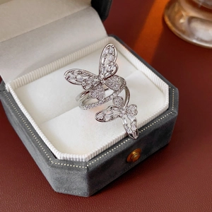 Macro shot of silver-tone hollow butterfly ring with micro-pave zircons on velvet box