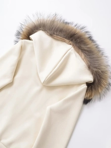 Detail of detachable brown faux fur collar on off-white hooded sweatshirt jacket