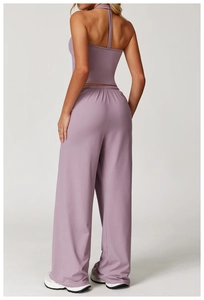 Rear view of a light purple yoga set featuring a halter tank top and wide-leg trousers