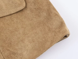 Detailed close-up showing the brown suede texture and premium stitching of the jacket