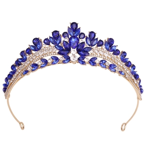 Close-up of golden bridal tiara with blue teardrop rhinestones and clear crystals