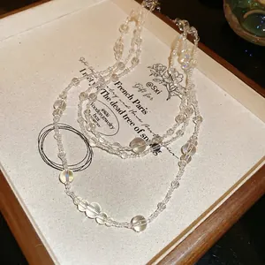 Elegant multi-layer clear glass bead necklace with a minimalist aesthetic for women