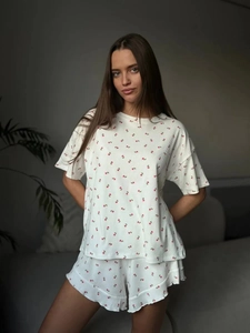 Detail of ruffle hem shorts and ribbed floral print fabric for women's loungewear set