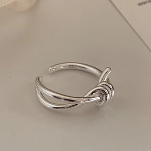 Macro shot of S925 sterling silver knot ring featuring adjustable open band design
