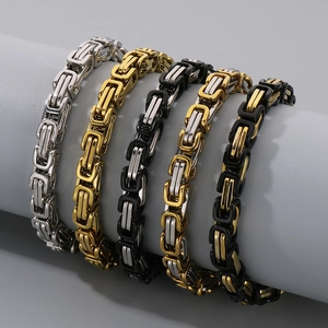 Byzantine chain bracelets in five metal tones displayed on a cylinder stand