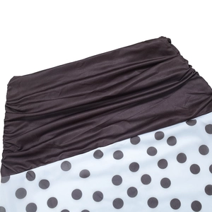 Detailed close-up of ruched black bodice stitched to classic white polka dot fabric