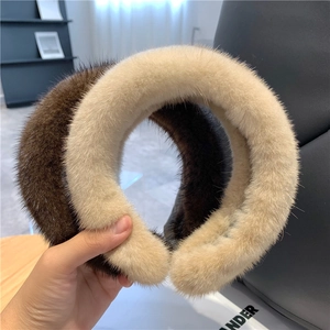 Detailed close-up of a plush two-tone faux mink fur headband in dark brown and beige