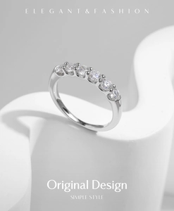 Macro view of minimalist S925 silver ring featuring seven sparkling round cut moissanite stones