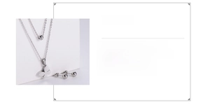Close-up of titanium steel jewelry set with butterfly pendant and ball stud earrings
