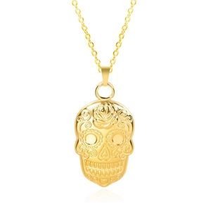 Detail of 18k gold plated sugar skull pendant with rose engravings on white background