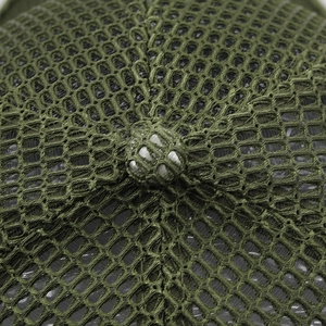 Close-up of army green mesh fabric and top button on a breathable baseball cap